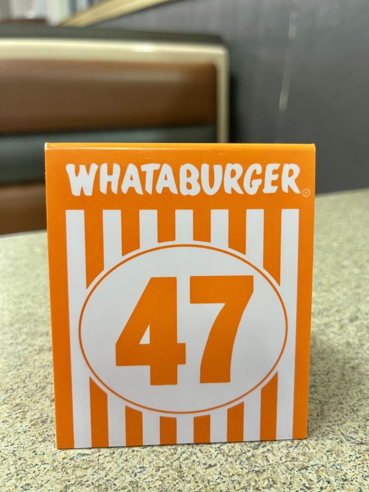 Whataburger table number 47 on a restaurant table.