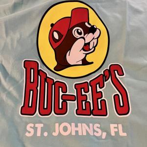 Aqua shirt with Buc-ee's logo, a beaver in a red cap, and text "ST. JOHNS, FL."