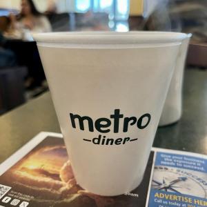 Metro Diner cup on a table in a restaurant setting.