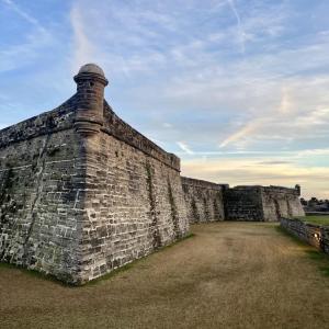 Historic stone fort under a cloudy blue sky.